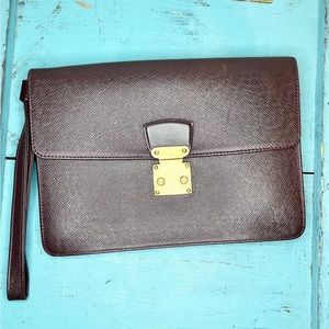 Louis Vuitton Taiga dragonne clutch with crossbody chain attachement.